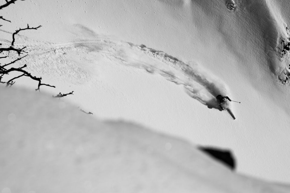 Carve. Christopher Cook drops a knee and cranks a fast telemark turn through perfect powder.