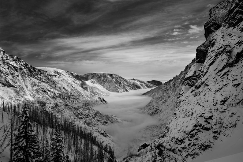 East Rosebud Canyon, Beartooth Wilderness, Montana. Fog rolls into the mouth of East Rosebud Canyon on a backcountry ski trip.