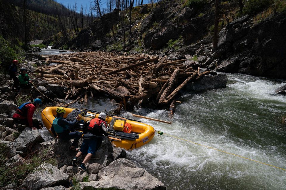 Five Mile Log Jam. A log jam nearly the size of a football field blocked the Middle Fork. The crew moves the raft over the last obstacle.