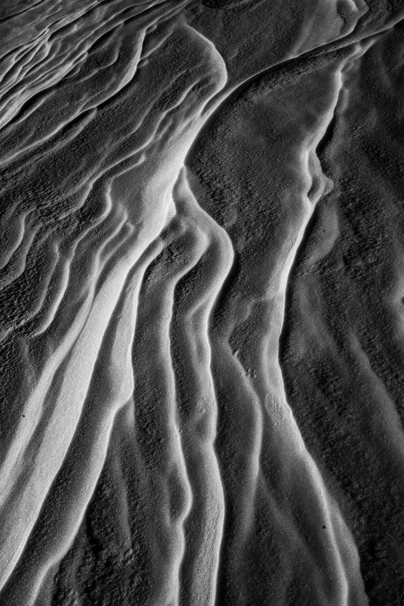 Sastrugi No. 2. Wind-carved ridges in the snow. Not the most fun to ski, but beautiful abstract shapes. Pairs with Sastrugi No. 1 as a diptych. Black and white.