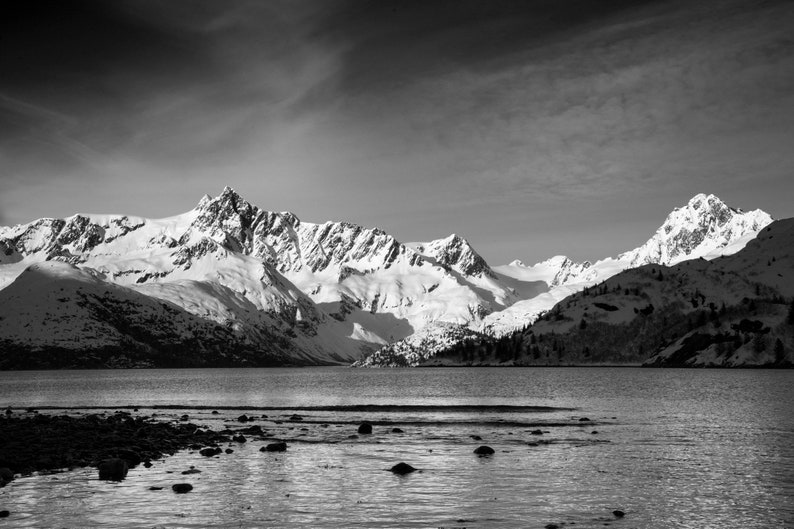 Steep Peaks of the Aialik Peninsula, Alaska. Peaks carved by glaciers rise straight from the ocean, seen from Harris Bay, Kenai Fjords National Park. Black and white.